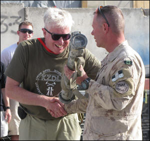 Bruce Cockburn receiving a rocket launcher from Gen. Jonathan Vance